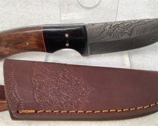 Mfg - Custom Hand Made Damascus
Model - Steel Knife 3.75" Blade
Located in Chattanooga, TN
This lot contains a Custom hand made Damascus steel knife. This knife has a 3.75" blade with black resin and wooden handle, overall length of 8.5". Full tang design with custom leather embossed sheath.
