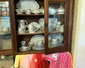 Antique china cabinet filled with Haviland china