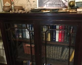 glassed in bookcase filled with fine old books--Can you see the interesting photographs from Lafayette's history