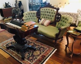 beautiful Victorian sofa and tables.  Notice the flip top game table in the middle of the room