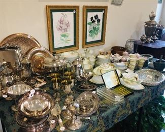 tables laden with early silverplate serving pieces