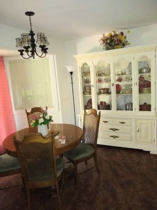 Cute dining table with leaves to expand and a white Hutch.