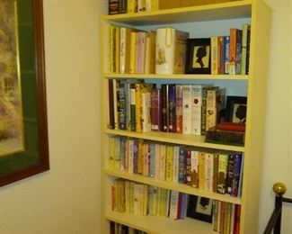 Lots of books on crafting and novels multiple bookshelves.