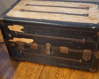 Antique steamer trunk with antique quilt, dress, child's dress, hats, and handkerchiefs