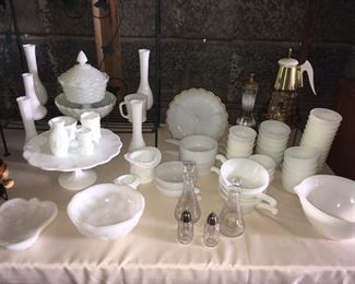 Milk Glass Serving Dishes. Large Measuring Bowl on the right, Ruffled Relish dish at back, Pedestal compote, Pedestal Cake Plate, Drinking Glasses & misc. Plus  Bud vases (are newer). 