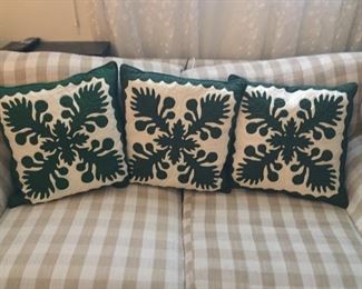 Hawaiian pillows and checked love seat.