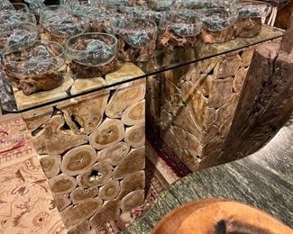 Teak wood slice console tables with glass tops