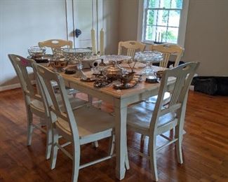 Large table with 6 chairs. Lots of silverplate. A couple of pieces of sterling.