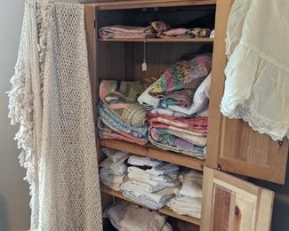 pine cupboard filled with old quilts and nice linens