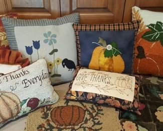 Some of the many beautiful accent pillows, and hooked items available.