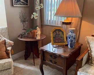Round corner table, art, orchid, and blue/white vase were sold.