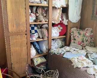 Antique cupboard with hand made pillows.