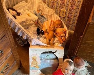 Baby bassinet with dolls.