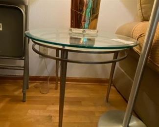 #59	round end table with glass top and stainless base 29x23	 $125.00 
