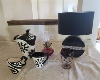 Home Decor with table lamp, oil lamp, candle holder, and black and white tea set