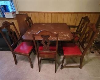 Vintage Drop Leaf Table with 1 Leaf and 5 Chairs. Located in Walkout basement.