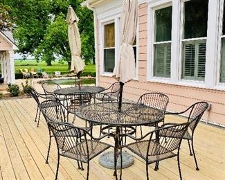Matching pair of wrought iron patio table and 6 chairs 