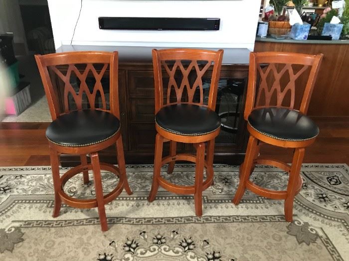 Set of 3 solid wood barstools with black vinyl seats, 24" to seat, 39" to top of backs