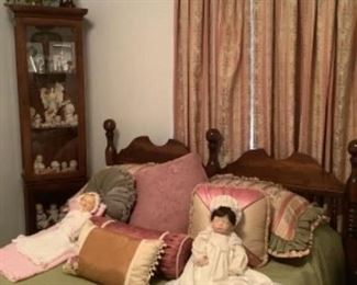 Full/queen bed with porcelain doll and antique doll resting on the bed!