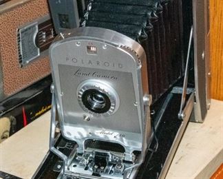 Three Polaroid cameras