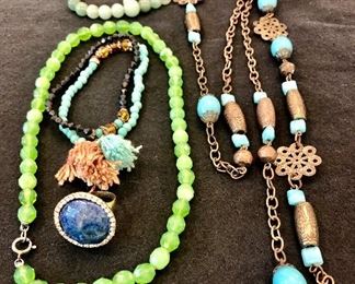 Item 407:  Green Stone Necklace: $14                                                    
Item 408:  Green beaded necklace: SOLD                                                          Item 409:  Set of two bracelets with tassels: $8                                          Item 410:  Long necklace with aqua stones: $14                                   
Item 411:  Blue Fashion Ring: $8