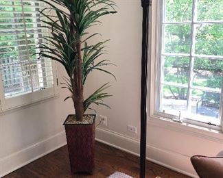 large faux plant and torchiere lamp