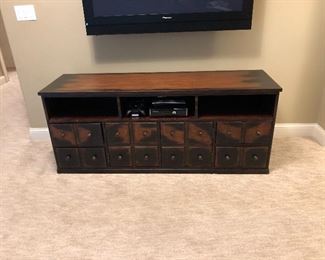 apothecary style media cabinet with 2 drawers on each side and center cabinet behind faux drawers