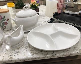 White serving pieces, soup tureen, platter, gravy