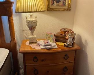 Pine bedside table with three drawers, vintage lamp, boxes, art