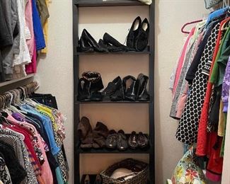 In the master bedroom you will find lots of great ladies clothing, shoes, boots, purses, cushions, black shelf unit and vintage two drawer chest