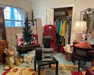 In this room, musical sound system, rugs, large soft toys, lighted Christmas tree, metal and glass coffee table, wonderful Queen upholstered bed.  Lots of ladies clothing, including seasonal items.