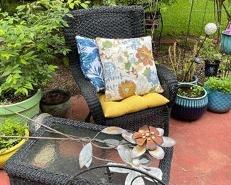Black wicker high back chair, table with glass top, yard art