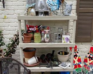 Lots of plant pots, vases, garden equipment, chemicals, yard art