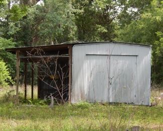 Shed with roof over style carport