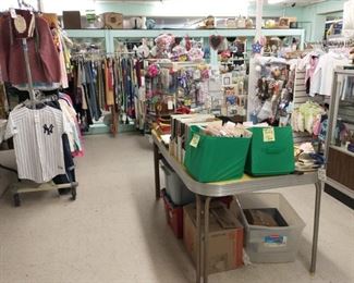Individually priced clothes (lots are brand new), vintage table with art magazines on top, flags, tablecloths, household items and baby and toddler clothes.