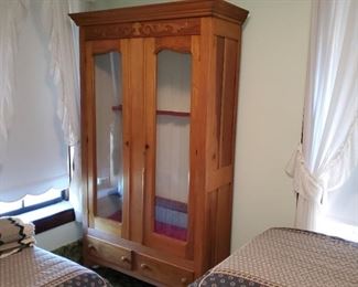 Gun cabinet or wardrobe (the wood piece in back is for storing guns)