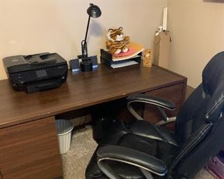 Nice wood desk, black desk chair, and printers