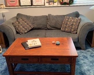 Gray sofa with pillows, nice mission coffee table