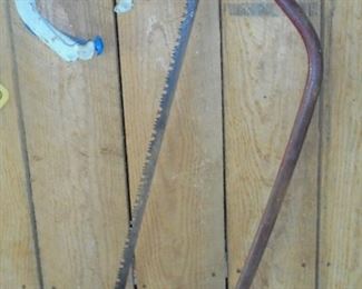 Vintage cross cut saw & horse shoes