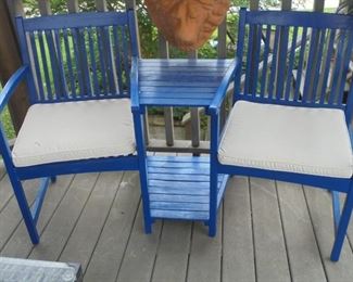 blue chairs w/table in between w/white cushions
