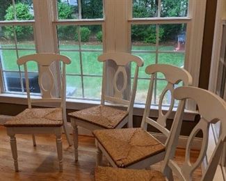 Four white kitchen chairs