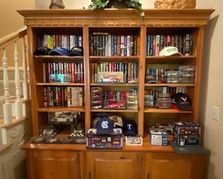 Book case with several books and model cars