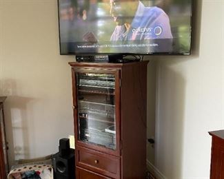 . . . another flat-screen TV (stereo cabinet and components are not part of the sale)