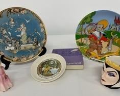 his lot includes a variety of pieces with a fairy tale theme. A Wedgewood 6" plate in its original box has a picture of The Frog Prince. A delicate statue of Tinkle Bell is Royal Dalton China from England, is numbered and is 5" tall. A beautiful plate from Villeroy & Boch in Germany marked 1980 and is a collector's piece. Puss & Boots are displayed on a 9-1/2" plate that has a hanger on back for ease of display. A Disney mug is in the shape of the Evil Queen from Snow White. 