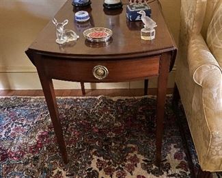 One of two antique drop leaf tables.