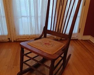1800s armless wooden rocker. No armrests because you hold your baby in your arms and rock the baby to sleep. 5(?) generations of my family were rocked in it and we turned out ok, mostly. Fragile.