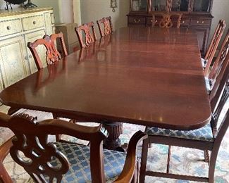 Mahogany dining table with leaves and 8 chairs. Table pads are included.