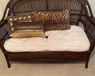 Rattan woven love seat with white cushion