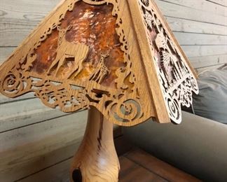 Beautifully wood carved lamp and base. Shade has Elk, Deer, Birds