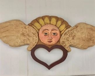 $75 Ceramic sun sculpture with wings and heart.  25" W x 9" H.  